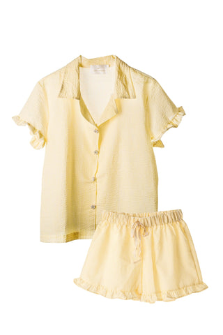 Yellow pajama set with a shirt and shorts on a white background
